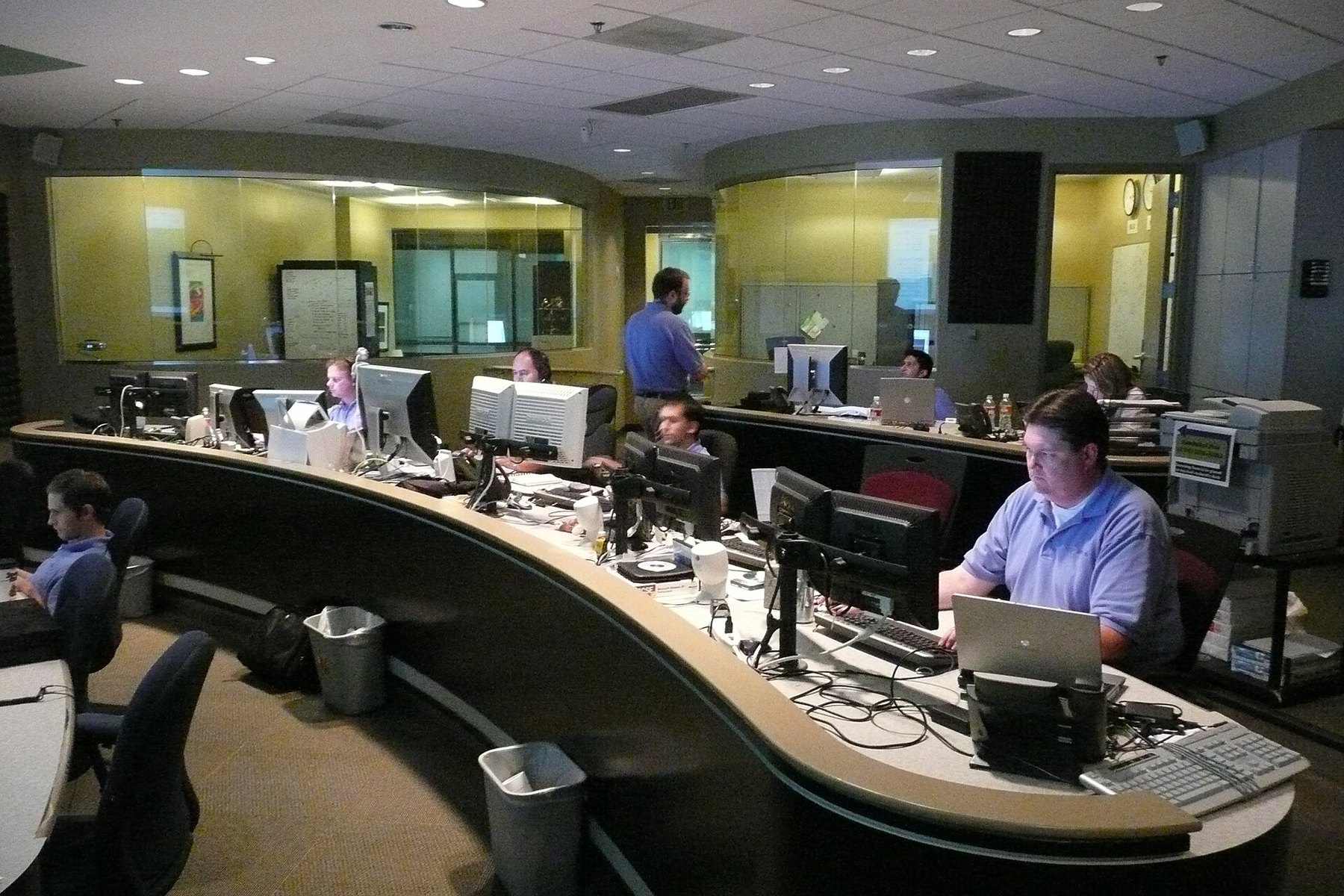 Network operations center with monitoring screens and workstations.