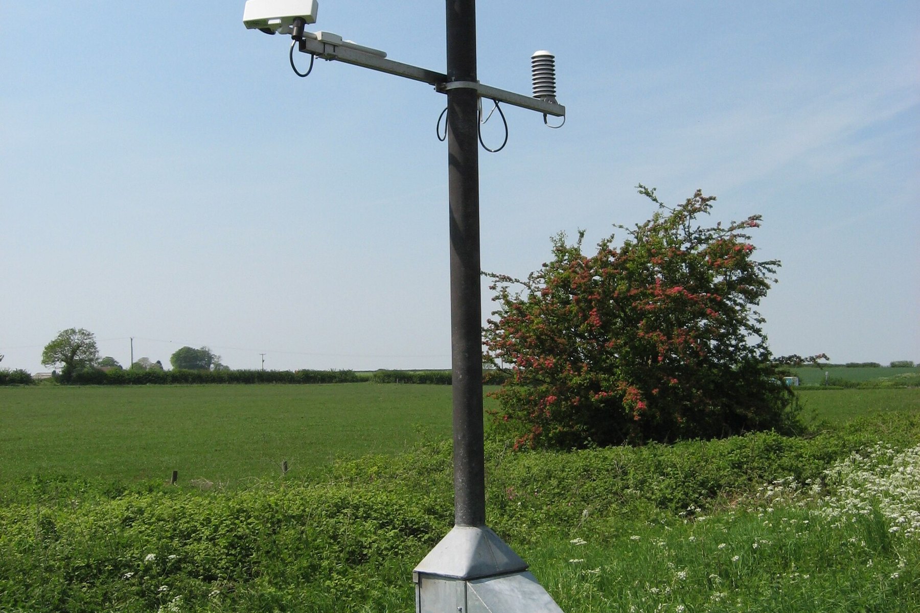 Automated roadside weather station monitoring infrastructure conditions.