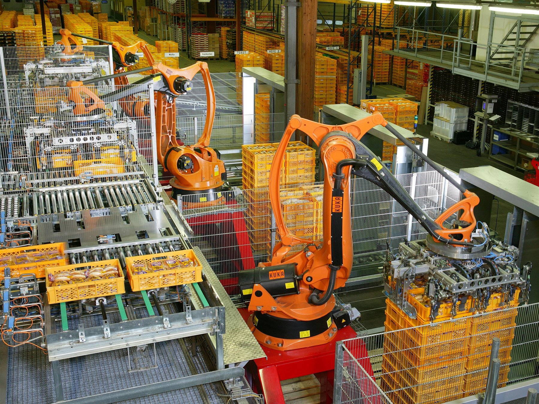Industrial robot arms operating in an automated production facility, representing robotics and physical AI.
