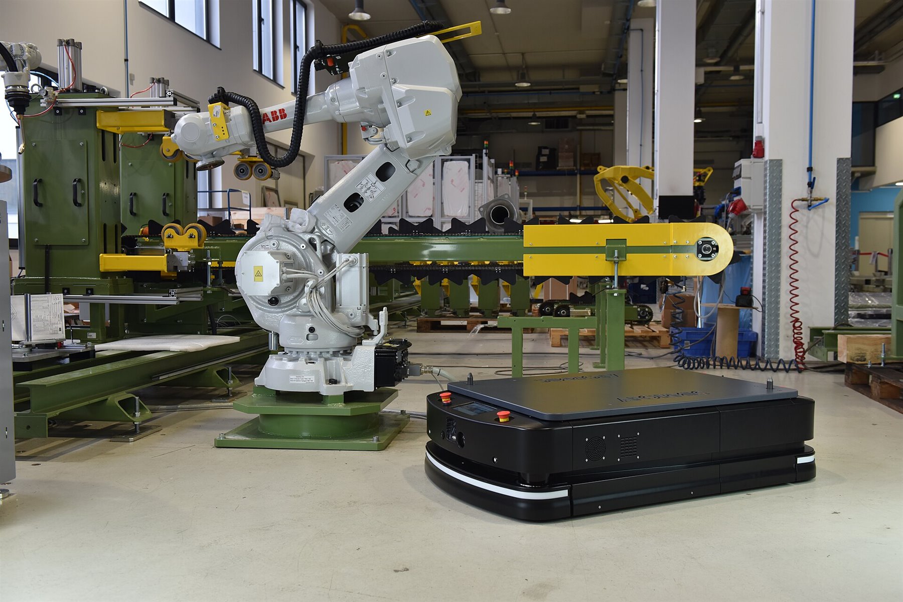 Automated guided vehicle in an industrial environment, representing robotics infrastructure beyond humanoids.